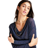 Woman wearing a blue top with a plain background