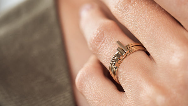 Woman hand on the neck showing the Fibonacci rings on three fingers