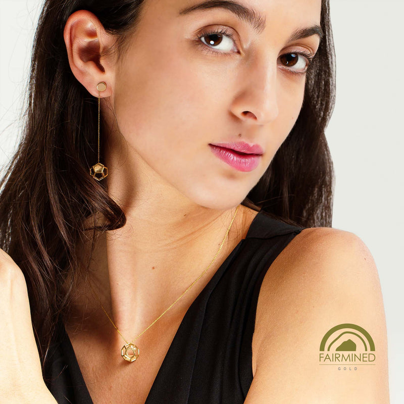 Woman wearing gold jewelry with Fairmined logo