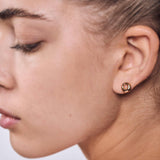 minrl aura earrings gold worn